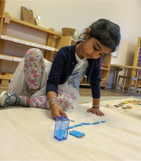 Child playing with educational counting beads.